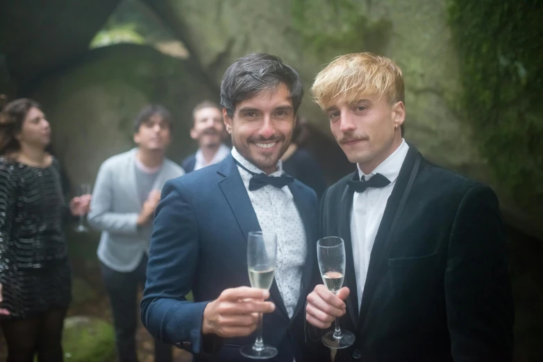 a couple of men standing next to each other holding wine glasses, liam brazier, many partygoers, alessio albi, profile image
