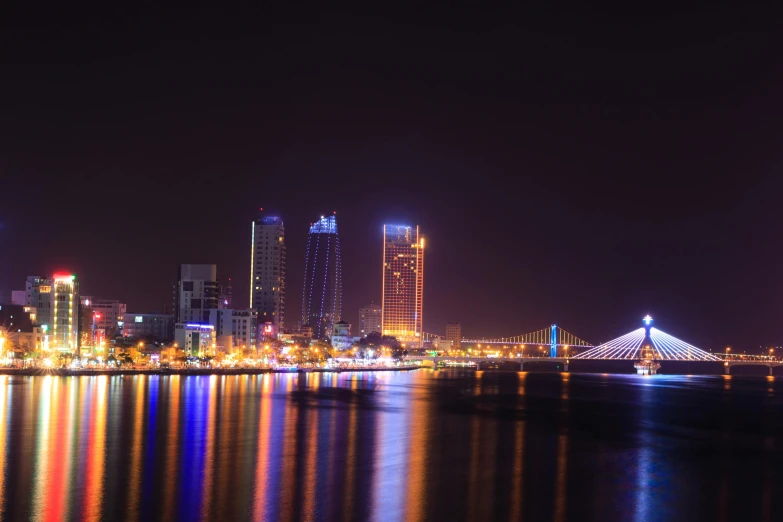 a view of a city at night from across the water, pexels contest winner, vietnam, aruba, square, gigapixel photo
