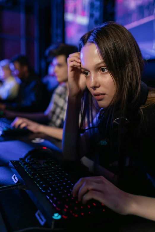 a woman sitting in front of a computer keyboard, esports, concerned expression, high school, center of picture