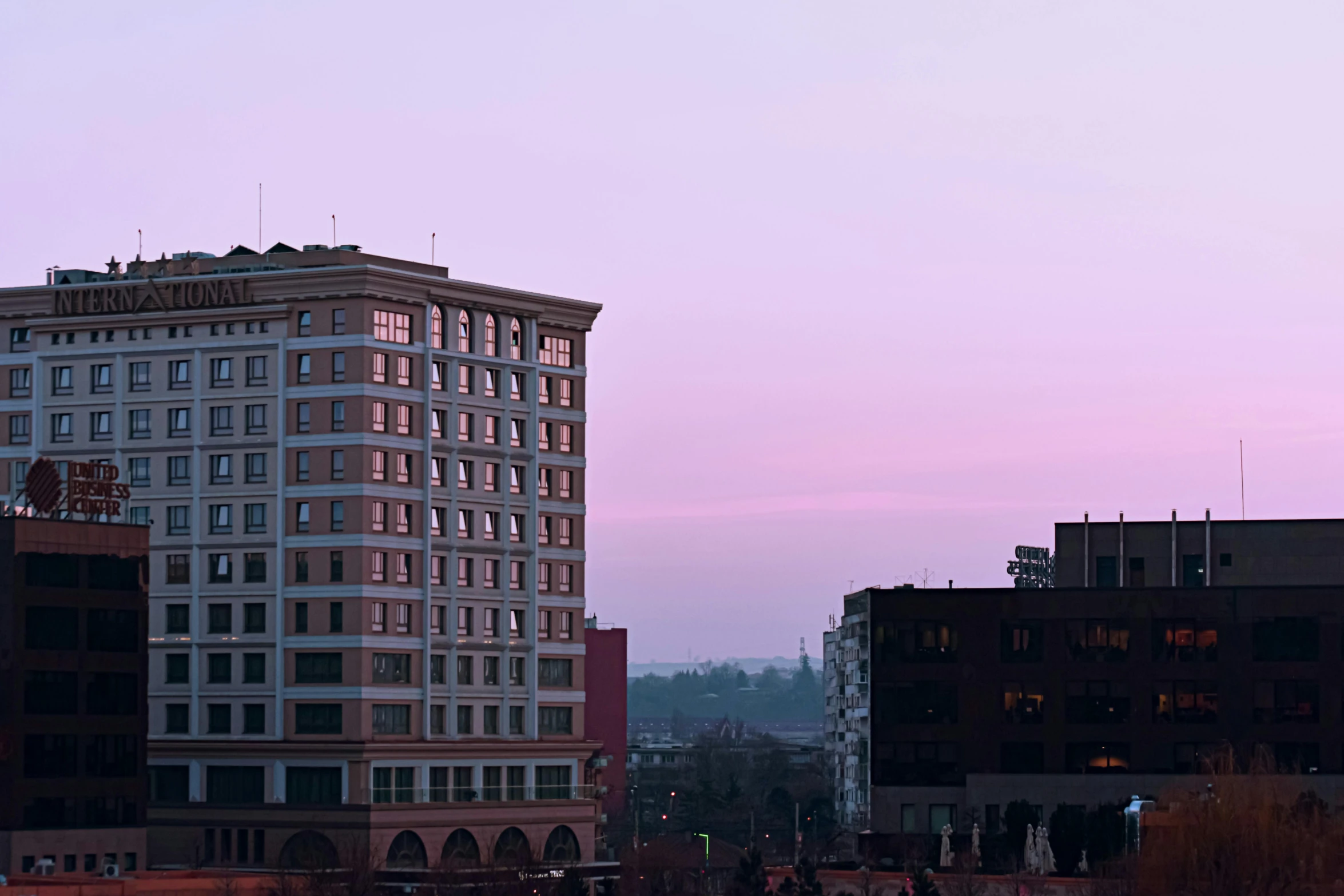 a couple of buildings that are next to each other, a photo, by William Woodward, unsplash, renaissance, at purple sunset, 2000s photo, loomis, downtown