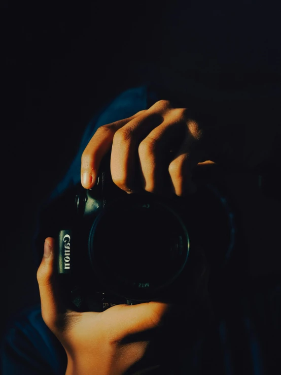 a person taking a picture with a camera, inspired by Elsa Bleda, dark backround, ansel ], the photography artwork, photography]