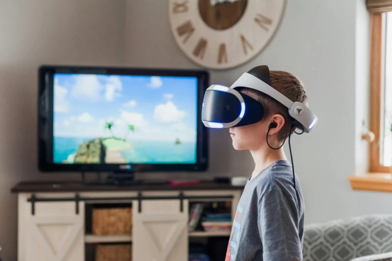 a young boy standing in front of a tv wearing a virtual reality headset, pexels, beautiful surroundings, from reading to playing games, avatar image