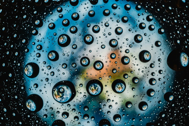 a close up of water droplets on a window, a microscopic photo, by Jan Rustem, pexels contest winner, photorealism, portholes, blue reflections, wet reflections in square eyes, by greg rutkowski