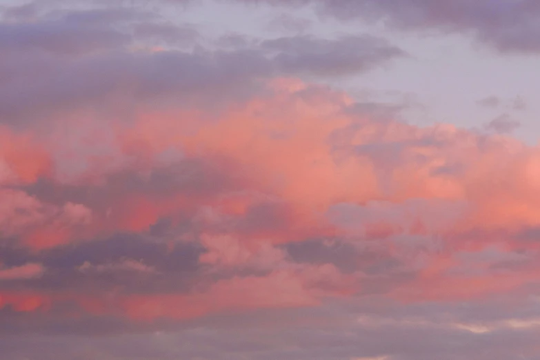 there is a plane that is flying in the sky, by Sophie Pemberton, unsplash, romanticism, barely lit warm violet red light, layered stratocumulus clouds, pastels, evening at dusk