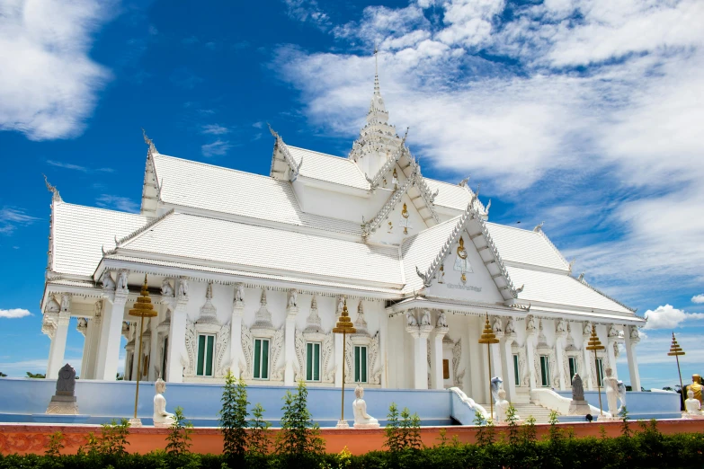 a large white building sitting on top of a lush green field, unsplash contest winner, thai temple, avatar image, square, white and blue