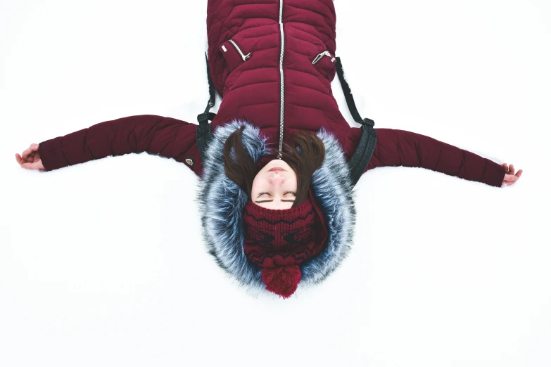 a woman laying on her back in the snow, pexels contest winner, maroon and white, head straight down, avatar image, full body shot 4k