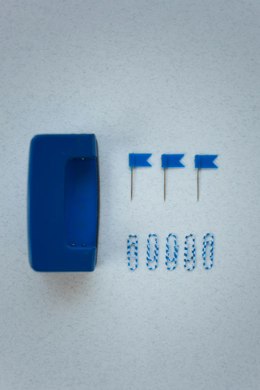 a close up of a blue object on a white surface, assembly instructions, flag, pins of light, full product shot