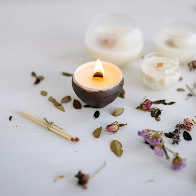 a group of candles sitting on top of a table, various items, with a white background, on wood, shot on sony a 7