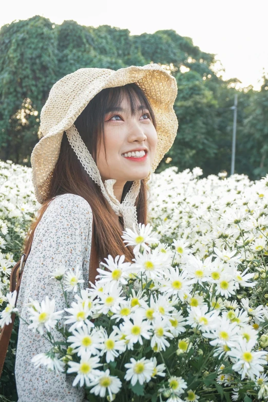 a woman standing in a field of white flowers, inspired by Ma Yuanyu, pexels contest winner, wearing a cute hat, young cute wan asian face, instagram post, daisies