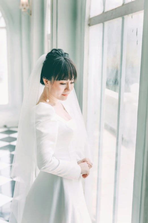 a woman in a wedding dress standing by a window, inspired by Kim Du-ryang, unsplash, with full bangs, square, long sleeves, 奈良美智