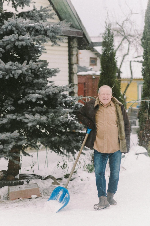 a man standing in the snow with a snow shovel, pexels contest winner, in a suburban backyard, avatar image, old male, photo of putin