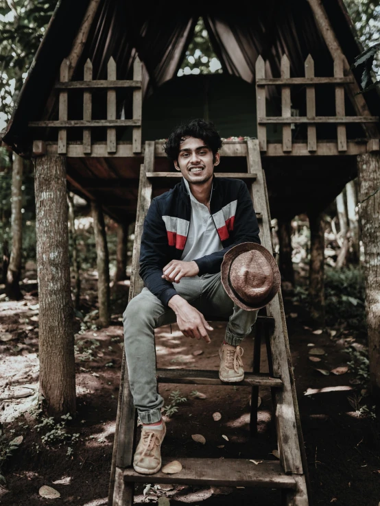 a man sitting on top of a wooden ladder, a picture, inspired by Adam Dario Keel, pexels contest winner, sumatraism, portrait of jughead jones, he is at camp, low quality photo, jayison devadas style
