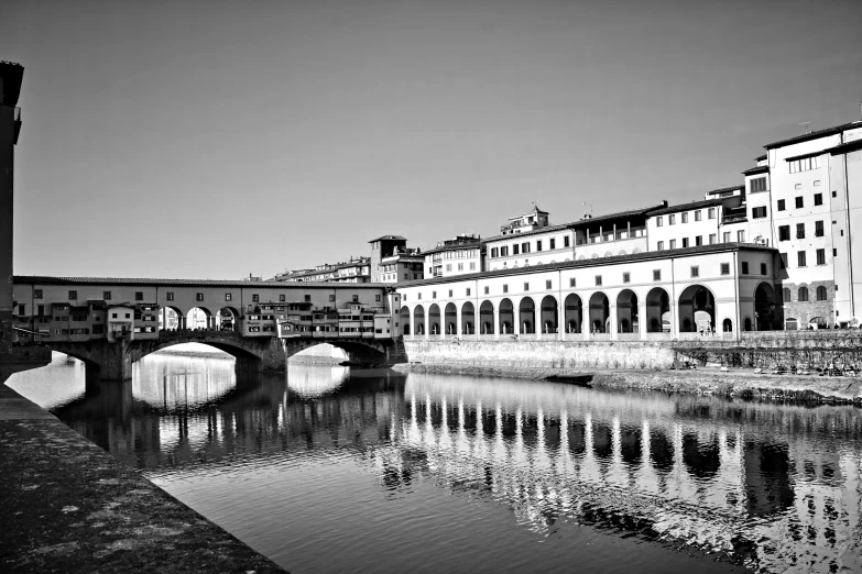 a black and white photo of a bridge over a river, a black and white photo, by Patrick Pietropoli, renaissance, fineartamerica, florence, 1024x1024, all buildings on bridge