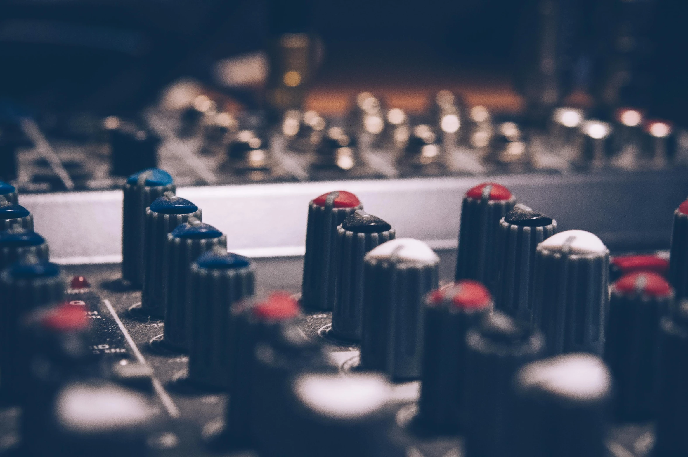 a close up of a mixing board with knobs, an album cover, by Matt Cavotta, trending on pexels, muted blue and red tones, radios, sitting at a control center, thumbnail