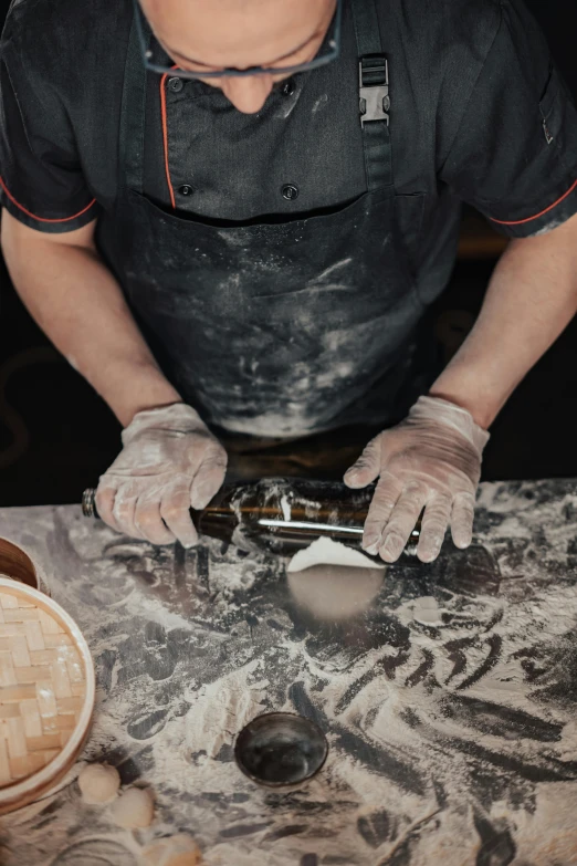 a man that is standing in front of a table, inspired by Gian Lorenzo Bernini, trending on unsplash, arbeitsrat für kunst, closeup of a butcher working, baking artwork, batik, aussie baristas