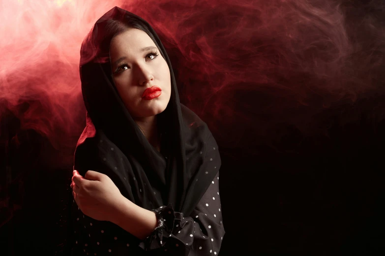 a woman standing in front of a red light, an album cover, by Julia Pishtar, pexels contest winner, hijab, in front of dark smoke, istockphoto, ((portrait))