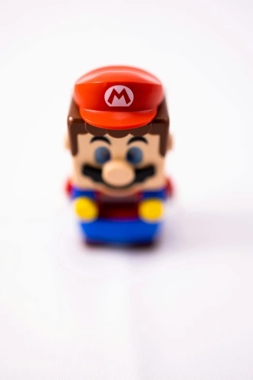 a close up of a toy on a white surface, inspired by Mario Comensoli, pexels, pixel art, photograph credit: ap, 2 5 6 x 2 5 6 pixels, ap news photo, hero