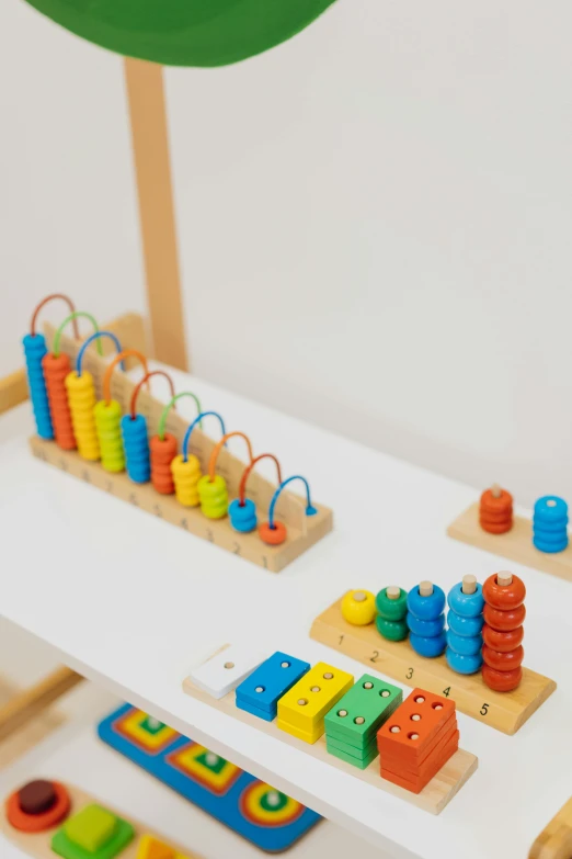 a table that has a bunch of toys on it, a picture, fibonacci sequences, detailed product image, up close image, wooden banks