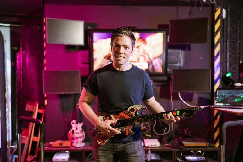 a man that is playing a guitar in a room, a portrait, in intergalactic hq, julian ope, in a studio, phil spencer