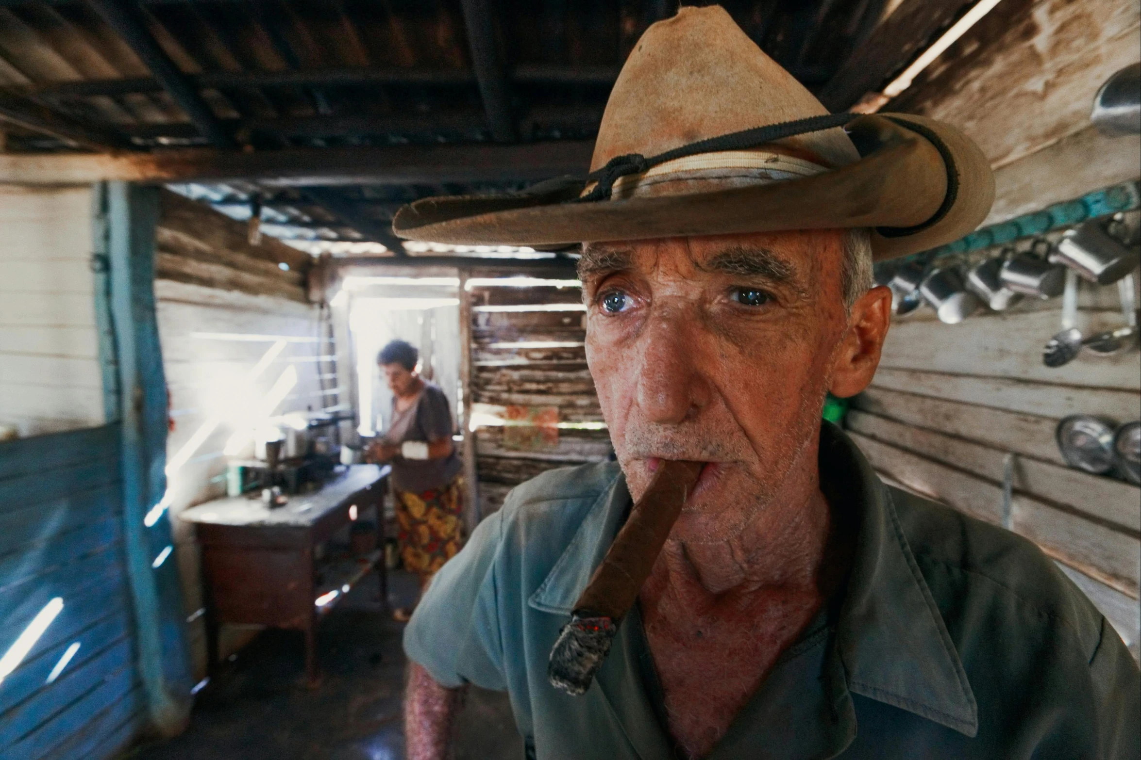 a man in a cowboy hat smoking a cigar, by Peter Churcher, apocalypse now, caravan, aussie baristas, two old people