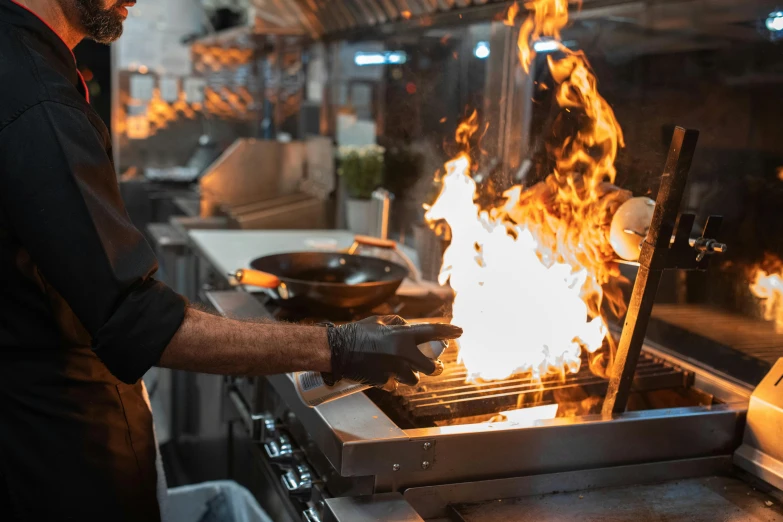 a man that is cooking some food on a grill, standing in a restaurant, fire punch, lachlan bailey, profile image