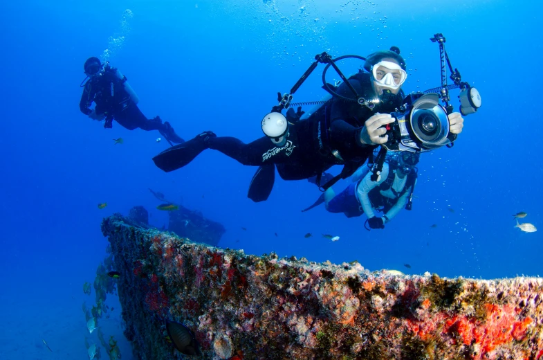 a couple of people that are in the water, pexels contest winner, old scuba, ultrawide lens”, color”, national geographic style”