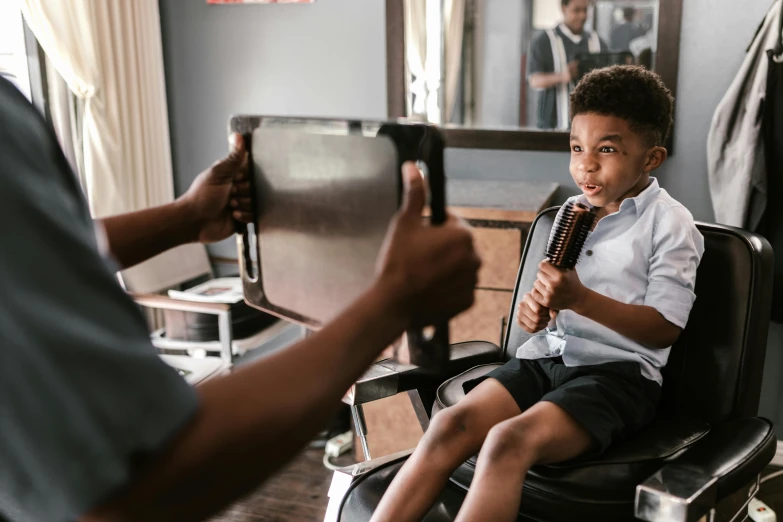 a little boy that is sitting in a chair, pexels contest winner, happening, diverse haircuts, black teenage boy, with a mirror, 15081959 21121991 01012000 4k