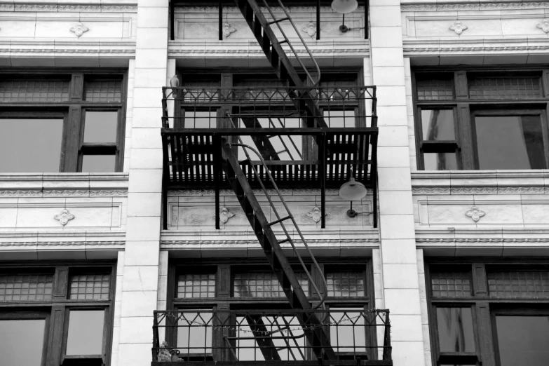 a black and white photo of a fire escape staircase, 2 0 1 0 photo, windows, high details photo