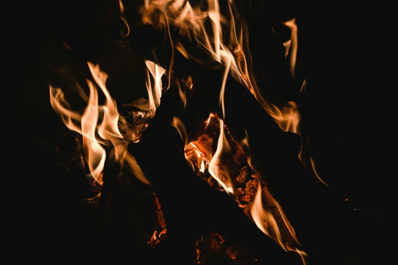 a close up of a fire in the dark, an album cover, pexels, background image, brown, multiple stories, woodfired