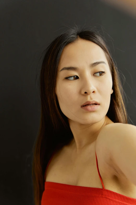 a woman in a red top posing for a picture, inspired by Kim Tschang Yeul, pexels contest winner, hyperrealism, sexy gaze, long chin, headshot half figure, ethnicity : japanese