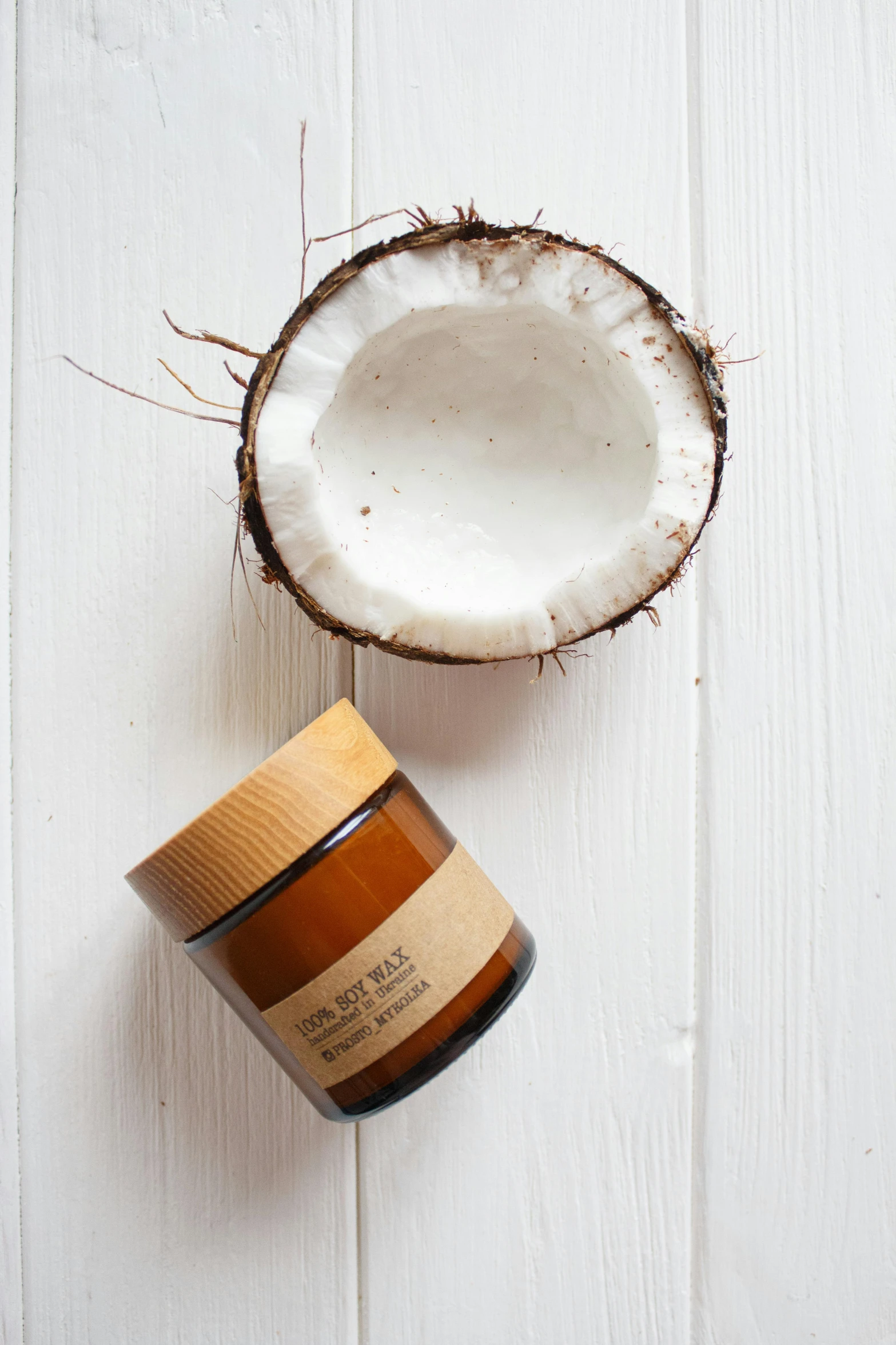 a jar of coconut oil next to a coconut, inspired by Ceferí Olivé, cosy vibes, natural wood top, thumbnail, look