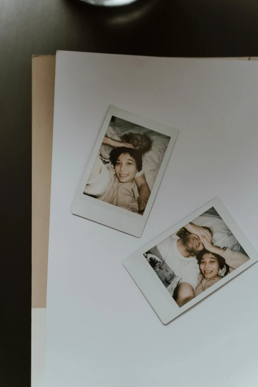 a couple of polaroids sitting on top of a piece of paper, trending on pexels, posing in a bedroom, beautiful faces, glossy photo, long distance photo