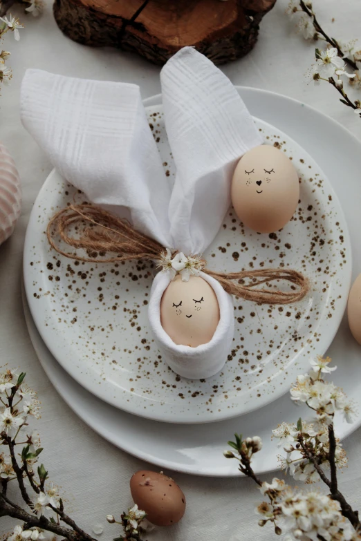 a couple of eggs sitting on top of a white plate, bunny head, handcrafted, angel in white linen, seeds