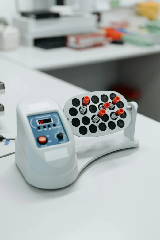 a close up of a device on a table, vials, press shot, system unit, high quality photo