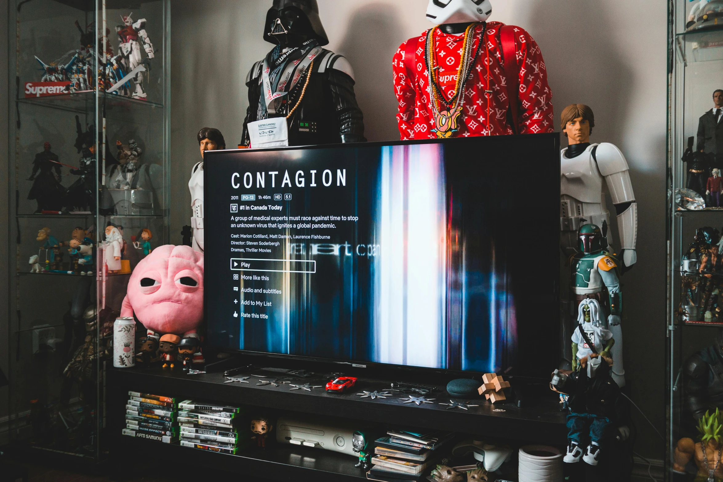 a flat screen tv sitting on top of a entertainment center, by Julia Pishtar, unsplash contest winner, context art, action figures, poster of corona virus, contaminated, playstation 3