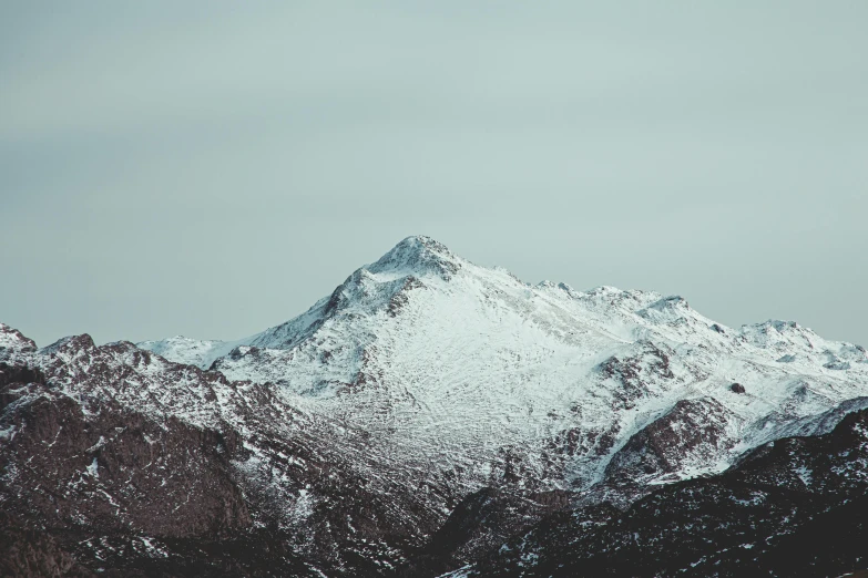 a large mountain covered in snow on a cloudy day, unsplash contest winner, minimalism, medium format, dusting of snow, portrait photo, 1 2 9 7