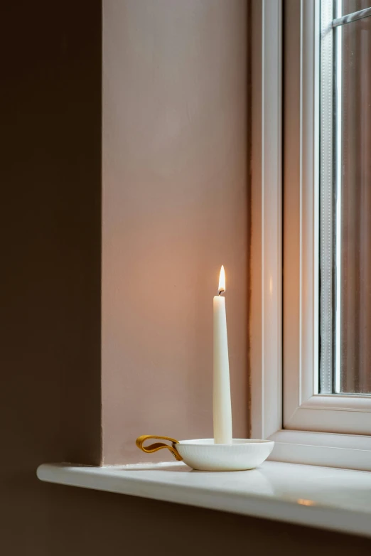 a candle that is sitting on a window sill, inspired by William Nicholson, minimalism, clamp shell lighting, thin porcelain, gold dappled light, spire