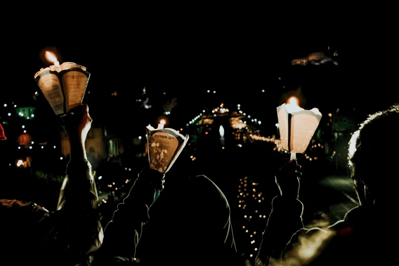 a group of people holding candles in their hands, by Adam Marczyński, trending on unsplash, renaissance, traditional corsican, overlooking a dark street, cardboard, background image