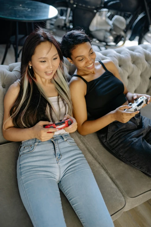 a couple of women sitting on top of a couch, trending on pexels, video game icon, half asian, her friend, casual playrix games