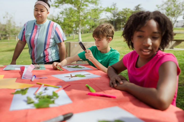 a group of young children sitting at a table, visual art, flying trees and park items, avatar image, tie-dye, getty images