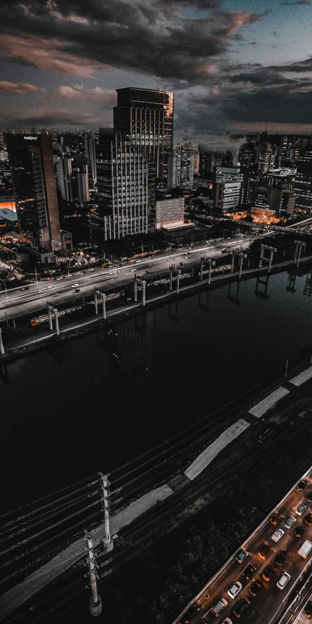 an aerial view of a city at night, an album cover, by Austin English, pexels contest winner, bridge, thumbnail, high quality photo, datapipeline or river