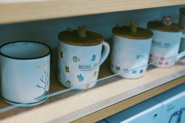 several coffee mugs are lined up on a shelf, by Emma Andijewska, small animals, close up details, cupboards, 8k 50mm iso 10