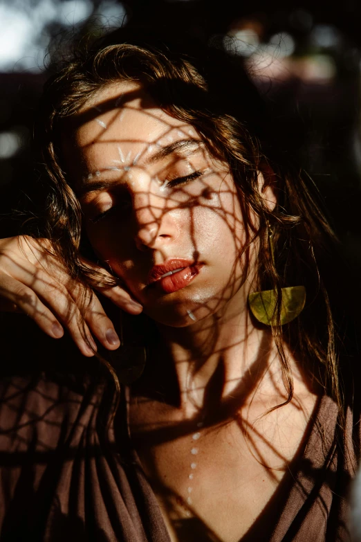 a woman with her hair blowing in the wind, inspired by Elsa Bleda, pexels contest winner, photorealism, seen through broken glass, portrait casting long shadows, red mesh in the facede, taken in the late 2000s