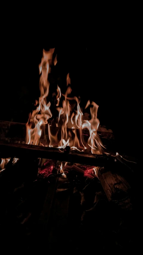a close up of a fire in the dark, an album cover, pexels, camp, brown, instagram post, profile image