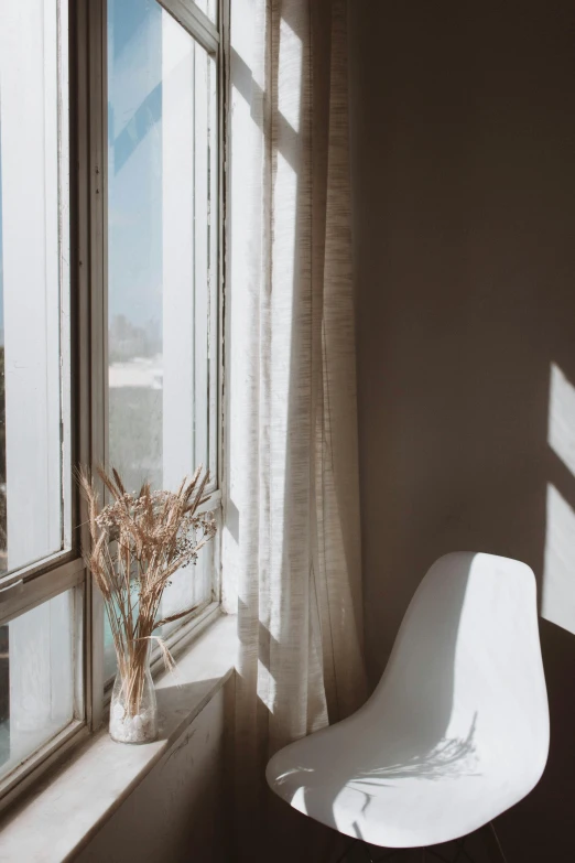 a white chair sitting in front of a window, inspired by Elsa Bleda, trending on unsplash, light and space, sunfaded, curtains, background image