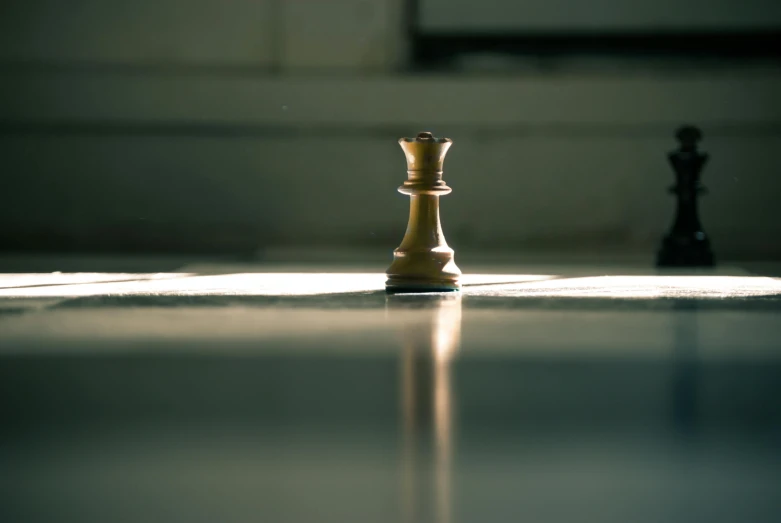 a close up of a chess piece on a table, a picture, by Jesper Knudsen, unsplash, postminimalism, kneeling at the shiny floor, natural light outside, the torch we all must hold, on a pedestal