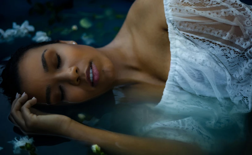 a woman laying in the water with her eyes closed, inspired by Elsa Bleda, pexels contest winner, renaissance, natural complexion, asian female water elemental, paradise garden massage, tessa thompson