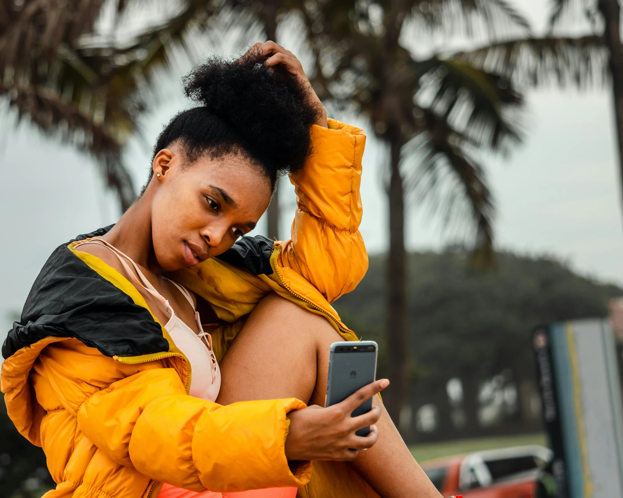 a woman sitting on a bench using a cell phone, trending on pexels, fine art, yellow clothes, black teenage girl, an ahoge stands up on her head, sexy girl with dark complexion