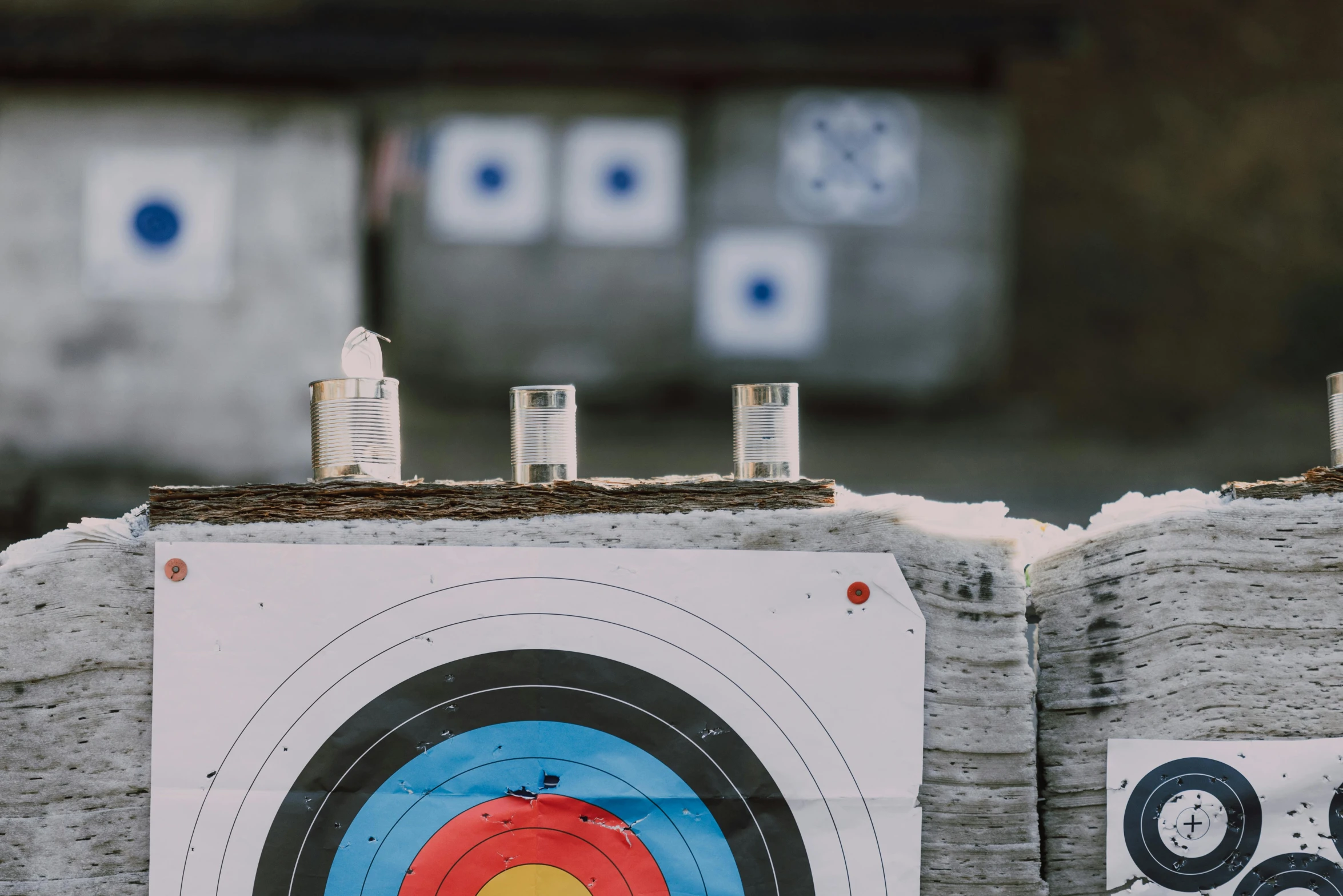 a close up of a target with a bulls eye, by Daniel Lieske, pexels contest winner, panoramic shot, rifles, ice arrows, exterior shot