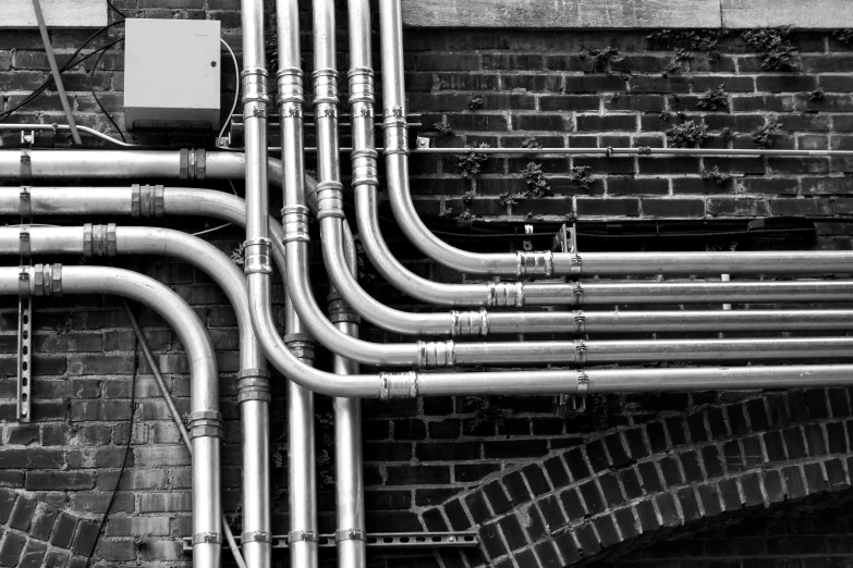 a black and white photo of a bunch of pipes, a black and white photo, pexels, art nouveau, connected trough wired, electrical arcs, industrial colours, corrugated hose